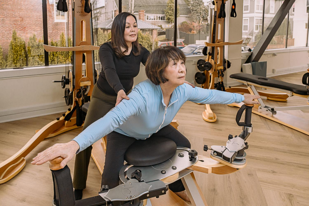 Senior woman in gym session with trainer